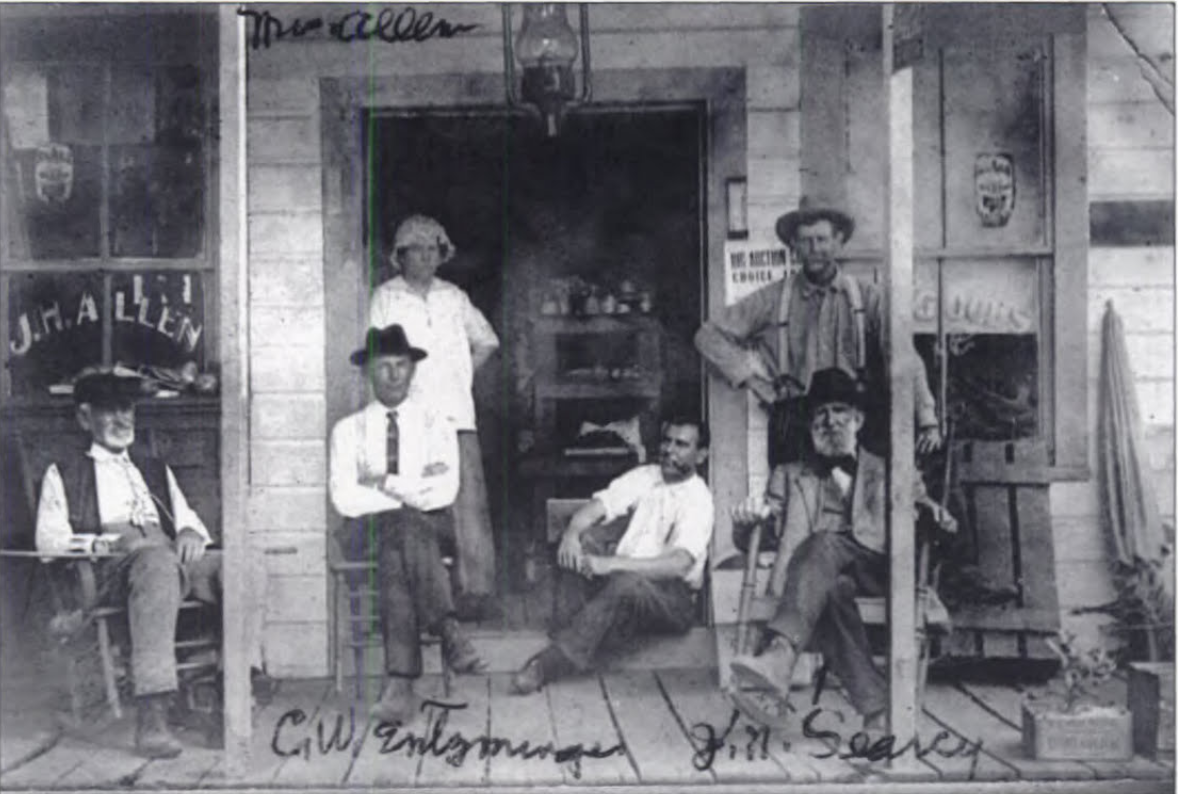 Prominent Longwood pioneers sitting on the front porch of the J. H. Allen store.