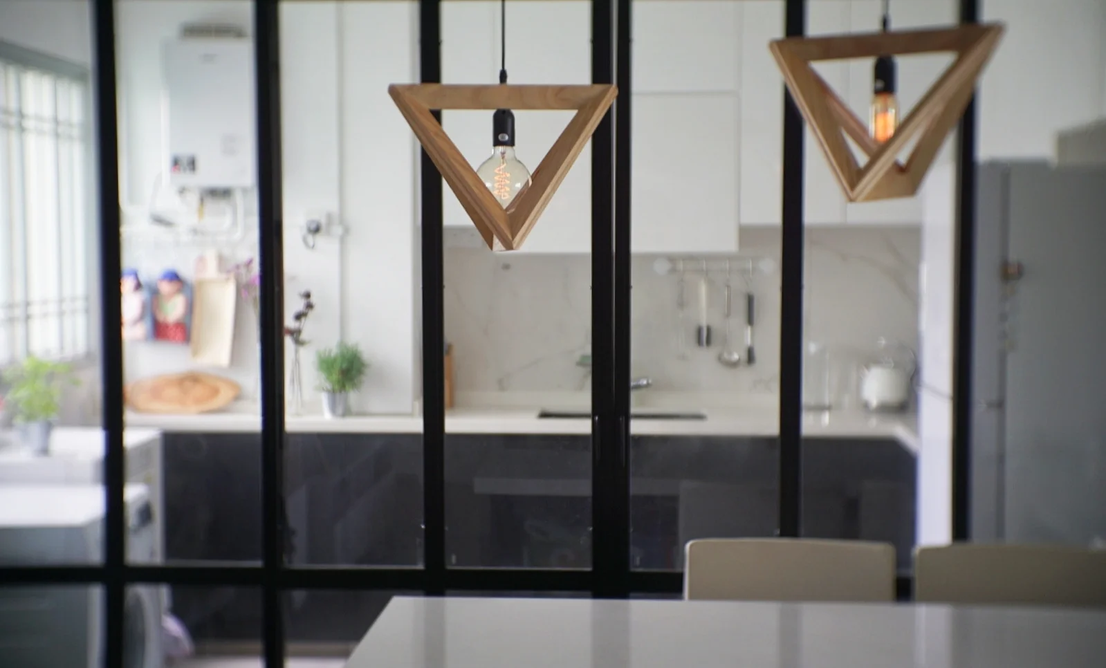 All-glass sliding doors with a metal frame help make the kitchen feel bigger.