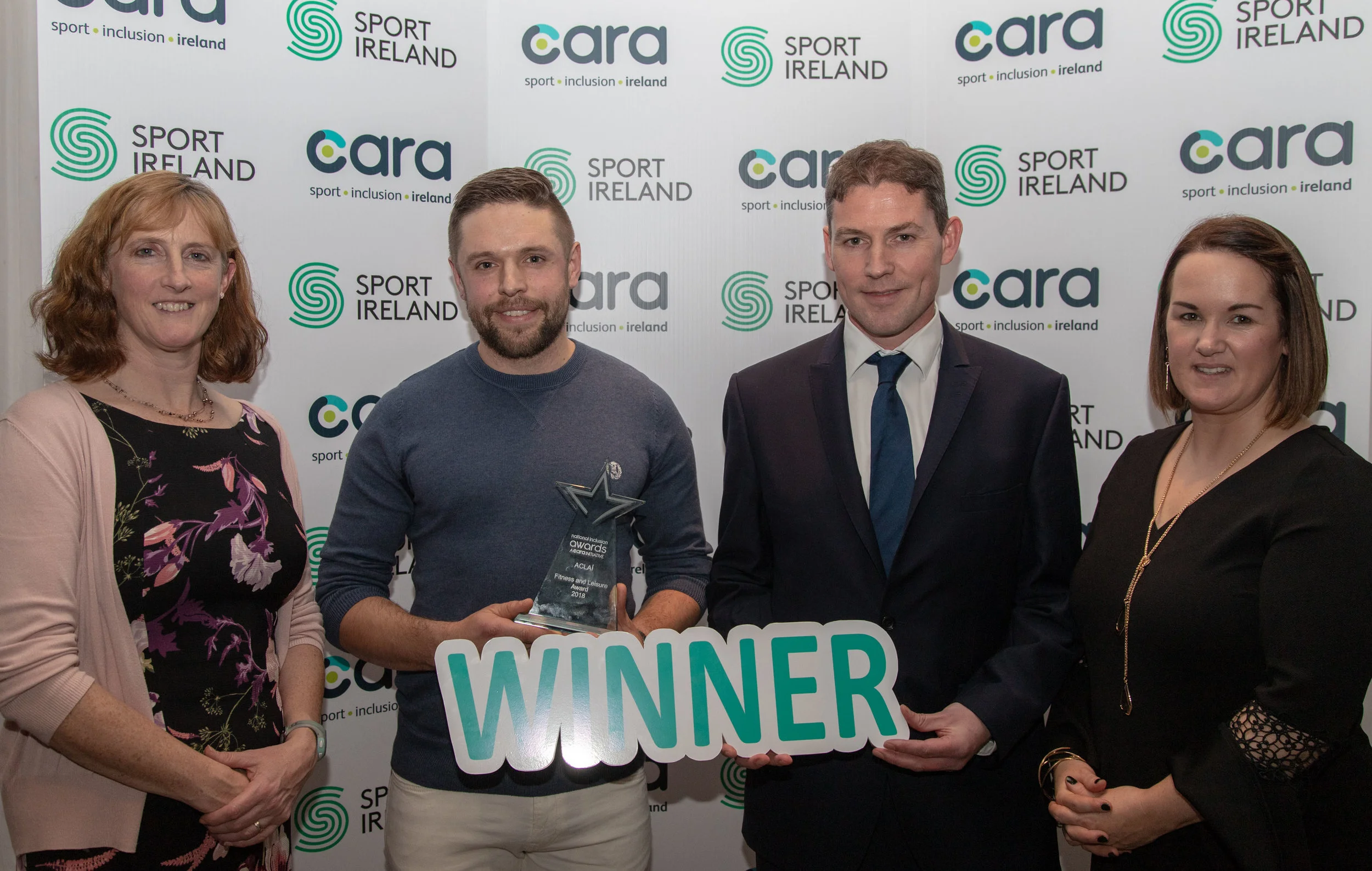 The National Inclusion Awards 2018 - Fitness & Leisure . L-R. Dr Una May ( Sport Ireland) , Winner ACLAÍ - Ainle Ó Cairealláin, Conn McCluskey (presenter) Niamh Daffy ( Cara)
