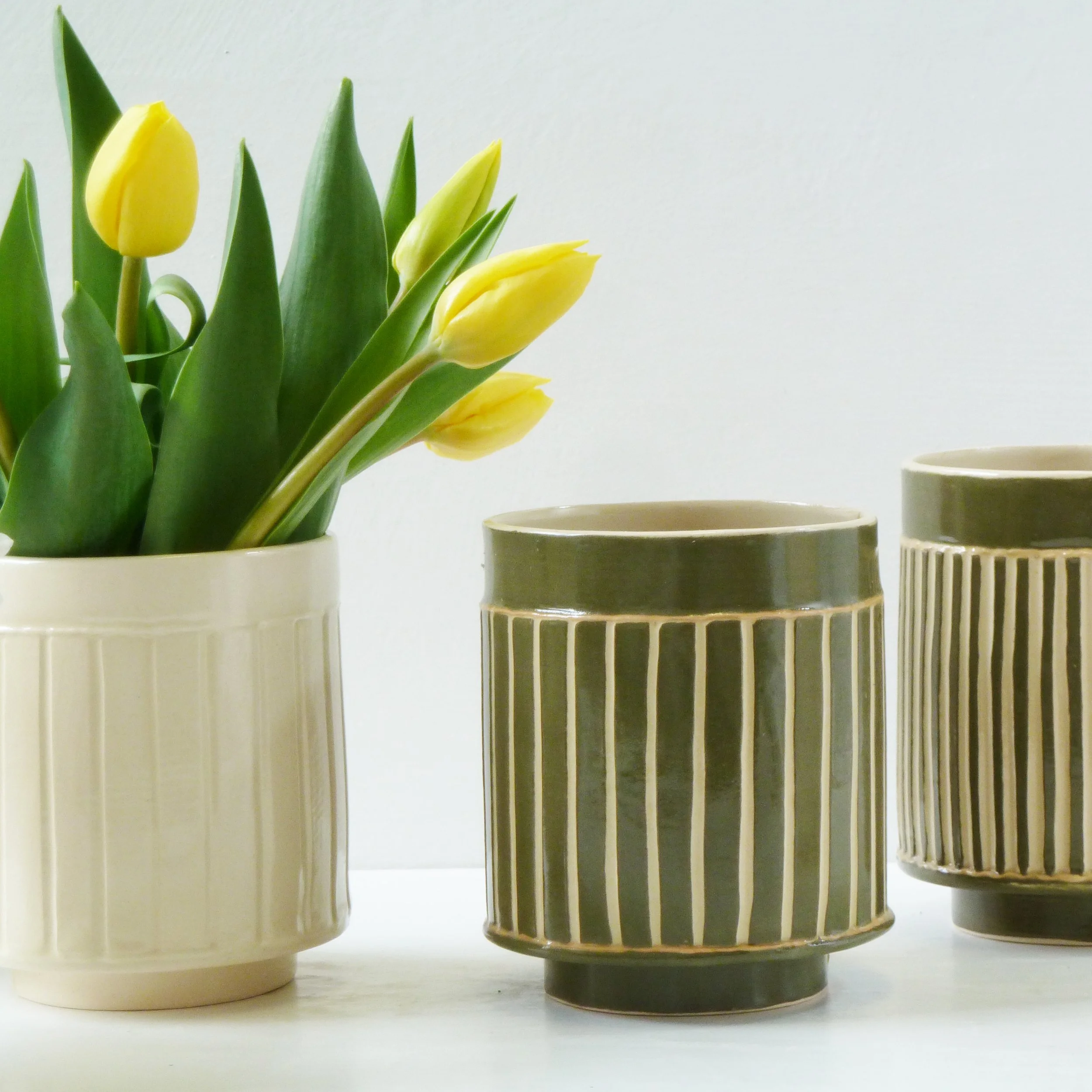 group of small vessels in green and white