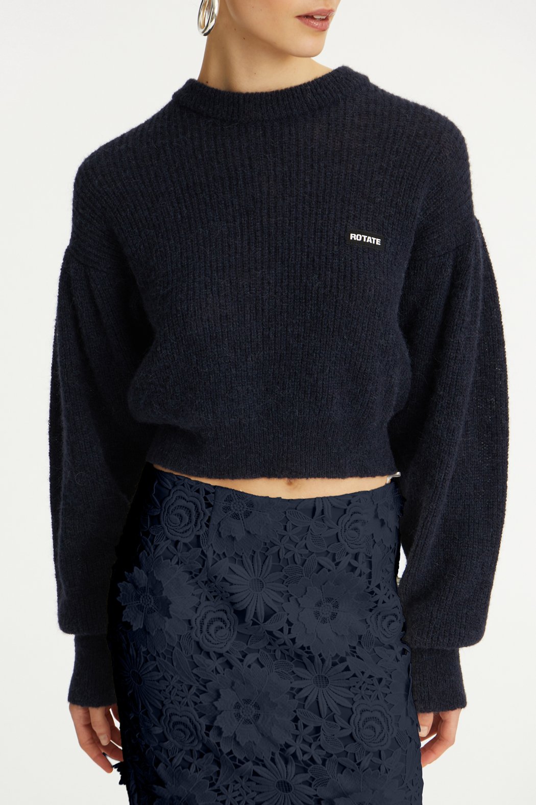 ROTATE_PF25_121124_1142781725_Navy Blazer_Knit Puff Crewneck_Model_ 1_115034 1725 _Navy Blazer_3D LACE PENCIL SKIRT_Model_ 1_3251_Navy_lr.jpg