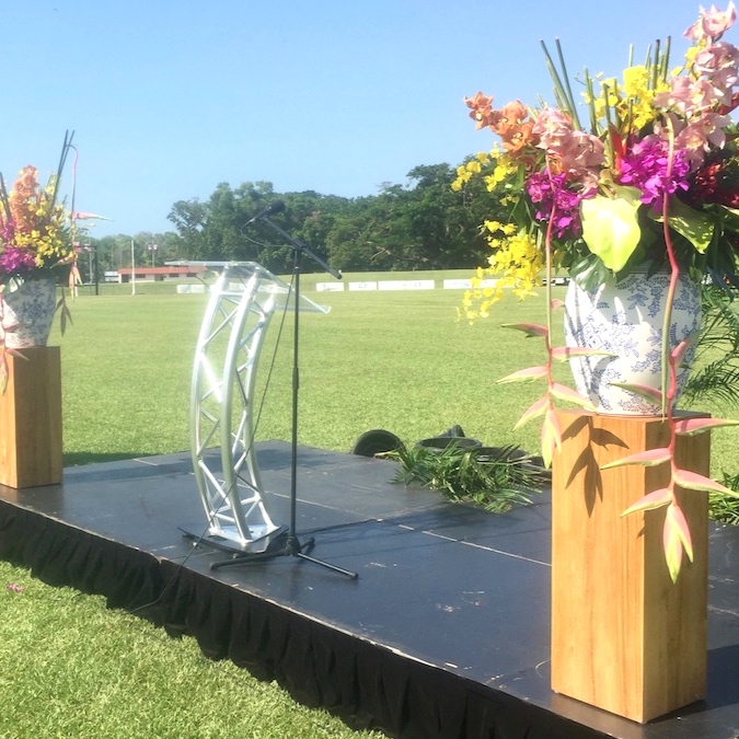 timber pillar with large vase of tropical flowers