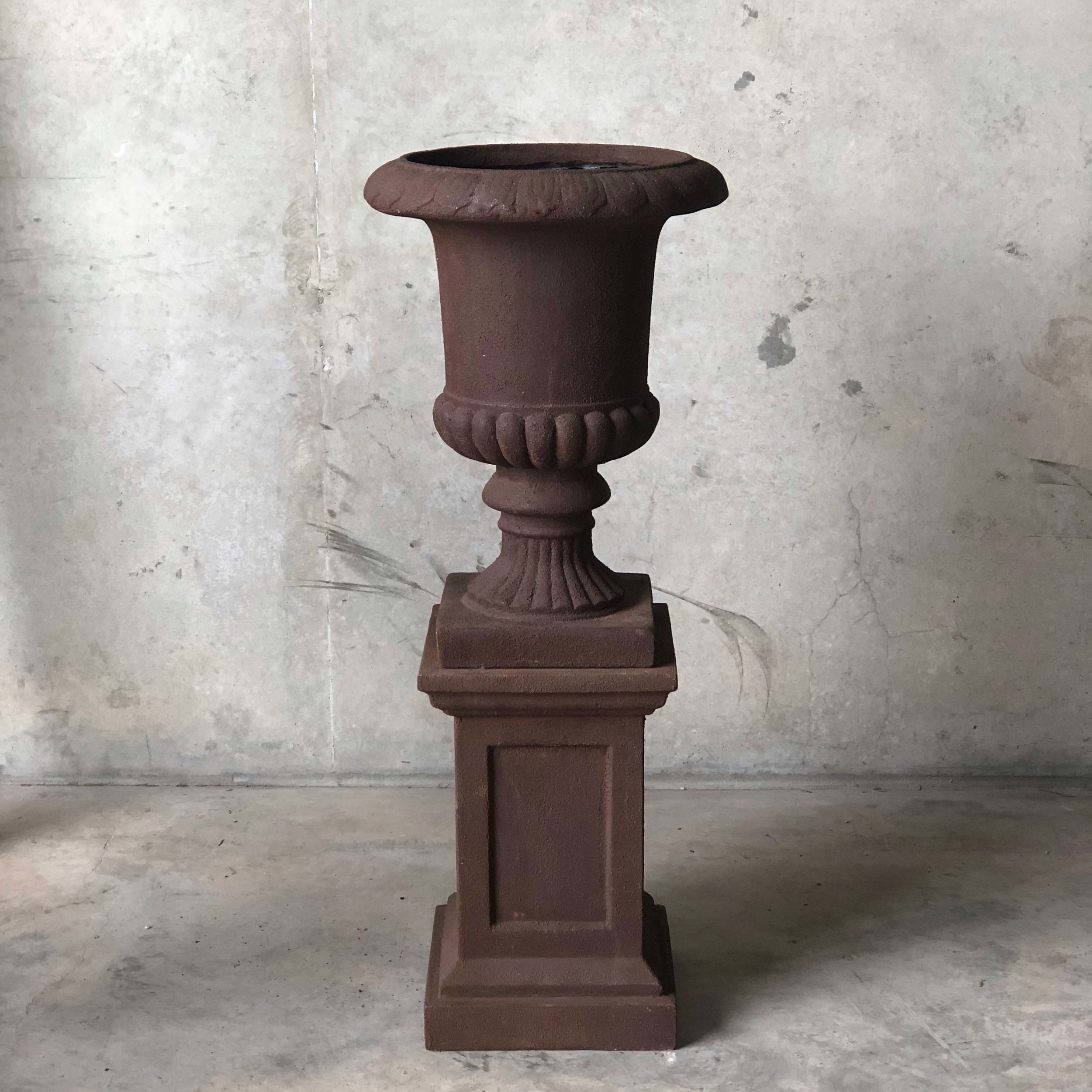 rust patina urn and matching pillar ideal for large scale floral arrangements in a traditional setting