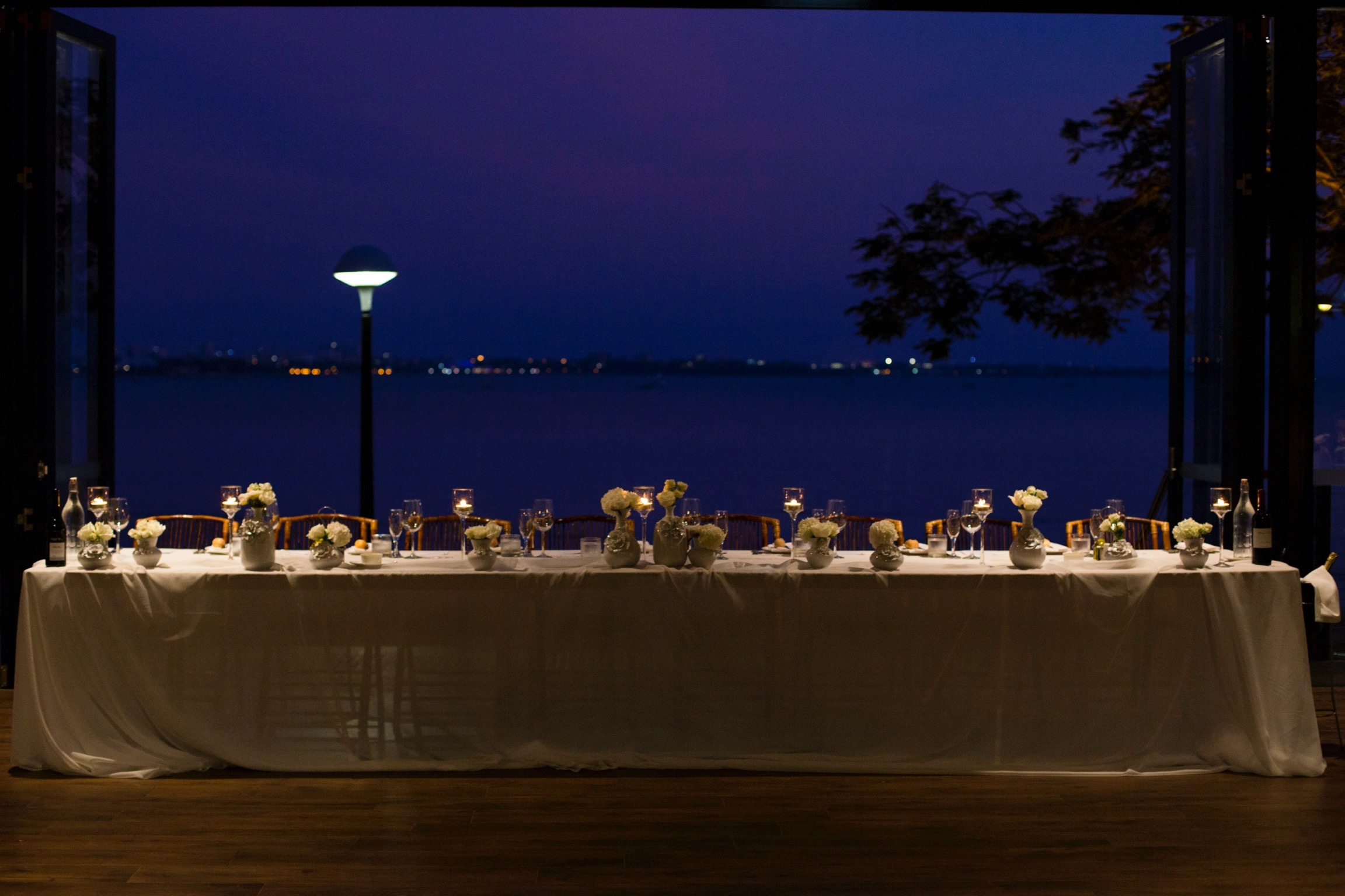 bridal table dressed with white roses and candlelight at Darwin wedding venue Pee Wees