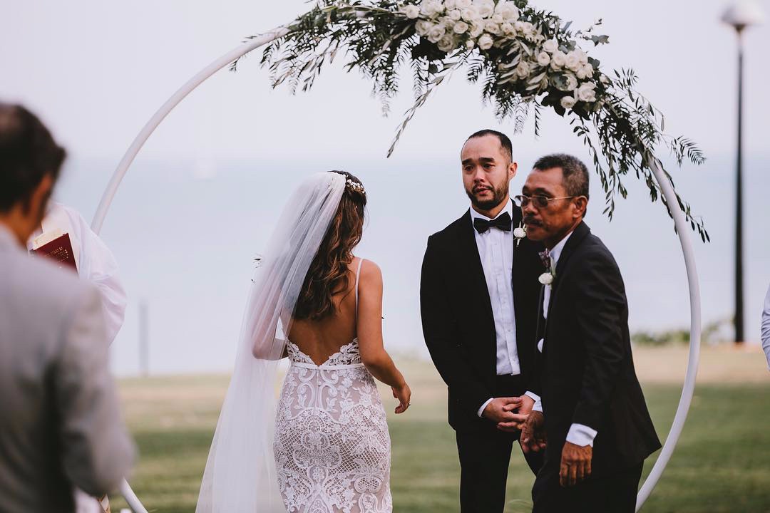 white floral for the ceremony hoop backdrop to this Darwin wedding ceremony