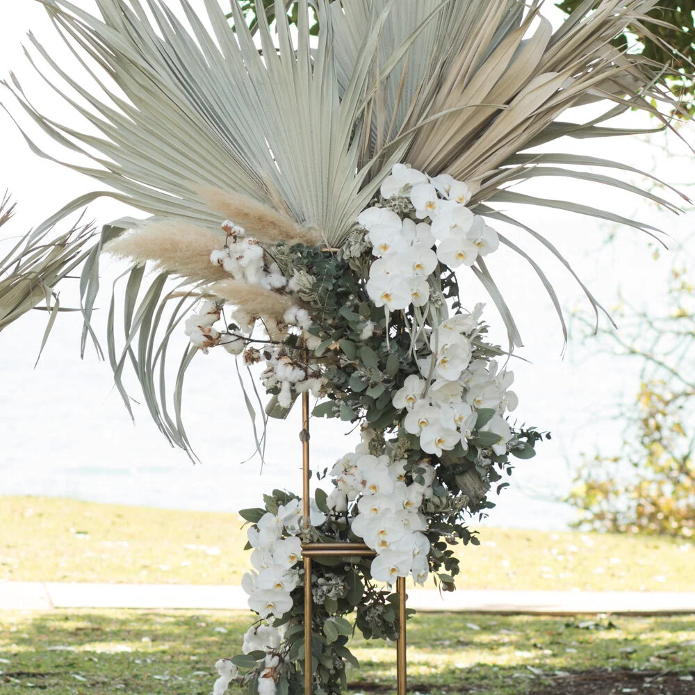 wedding ceremony backdrop with preserved flowers and orchids