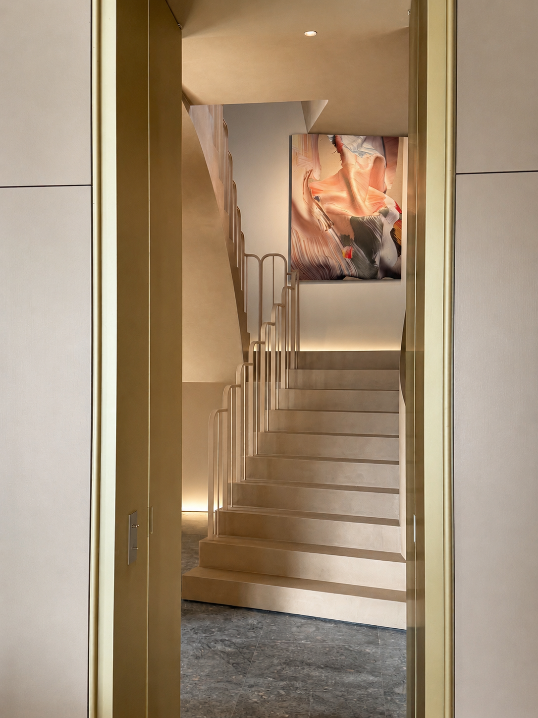22. Portal to the stairs: View through a refined gold portal opening up to the architectural staircase developed with Studio Nine Dots Amsterdam, flooding the heart of the home with natural light.
