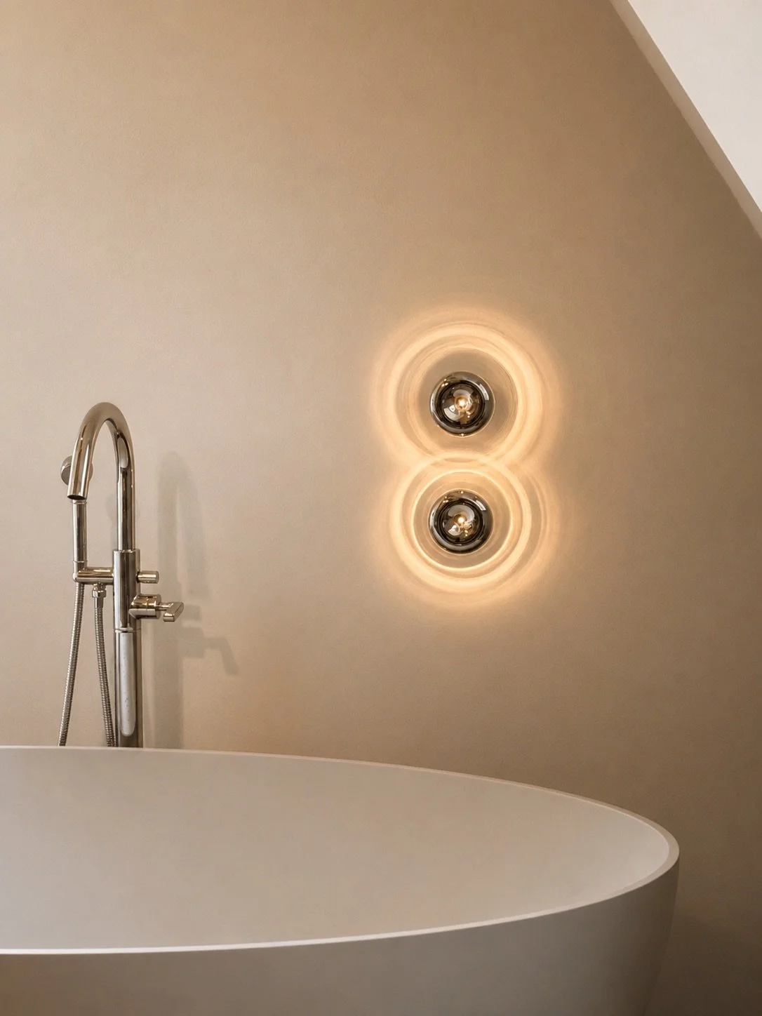12. Sculptural bathtub: Soft, semicircular freestanding bathtub paired with spherical Viabizzuno glass wall lamps and Watermark collection fixtures.