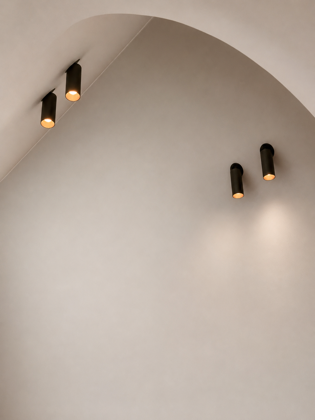 9. Minimalist lighting: Detail of minimalist bronze Prado recessed architectural spotlights illuminating the interior surfaces.