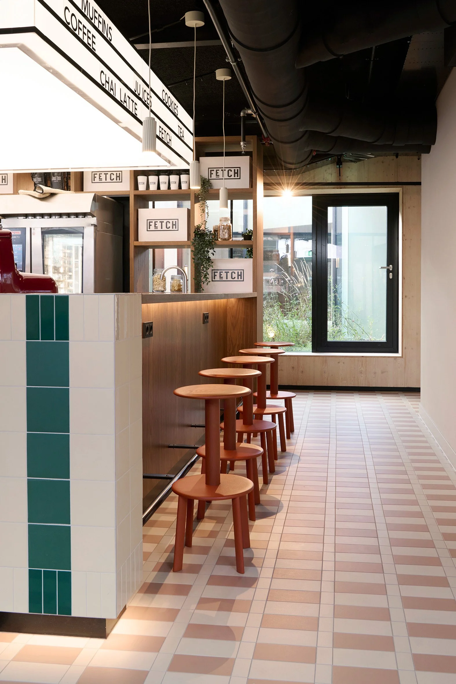Informal deli seating with red &Tradition stools.