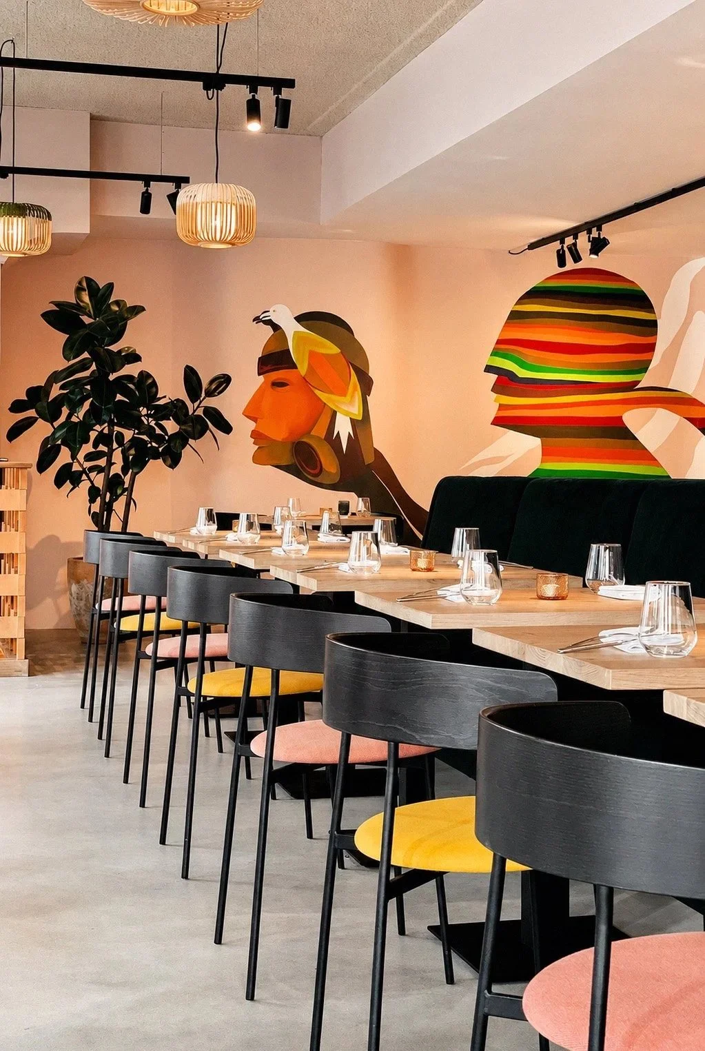 Dining area: Vibrant seating area with colorful wall art, capturing the lively Peruvian spirit of Nazka restaurant.