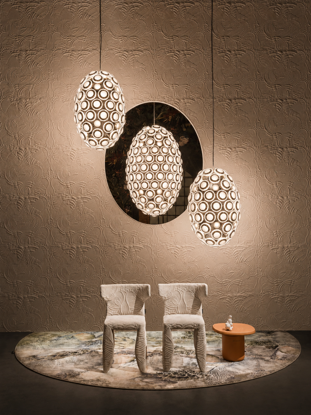Seating area detail: Lateral view of Moooi seating arrangements designed by Studio Michiel Wijnen, illuminated by spherical pendant lamps over a circular floral rug.