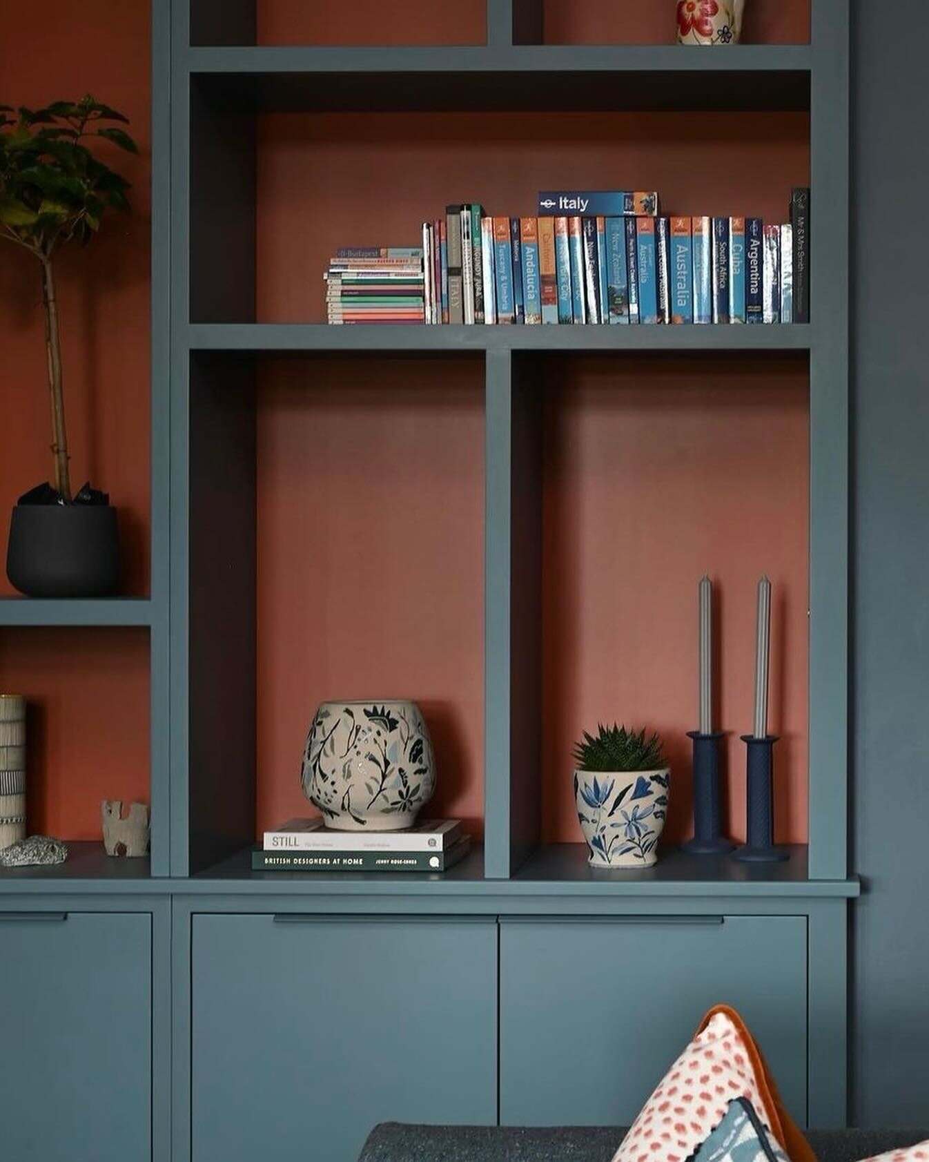Painting your cabinetry a rich colour can create the perfect backdrop to showcase your favourite books and treasures. 

Here is an example of how to style collections of objects and books to create an interesting display. We chose a warm terracotta f