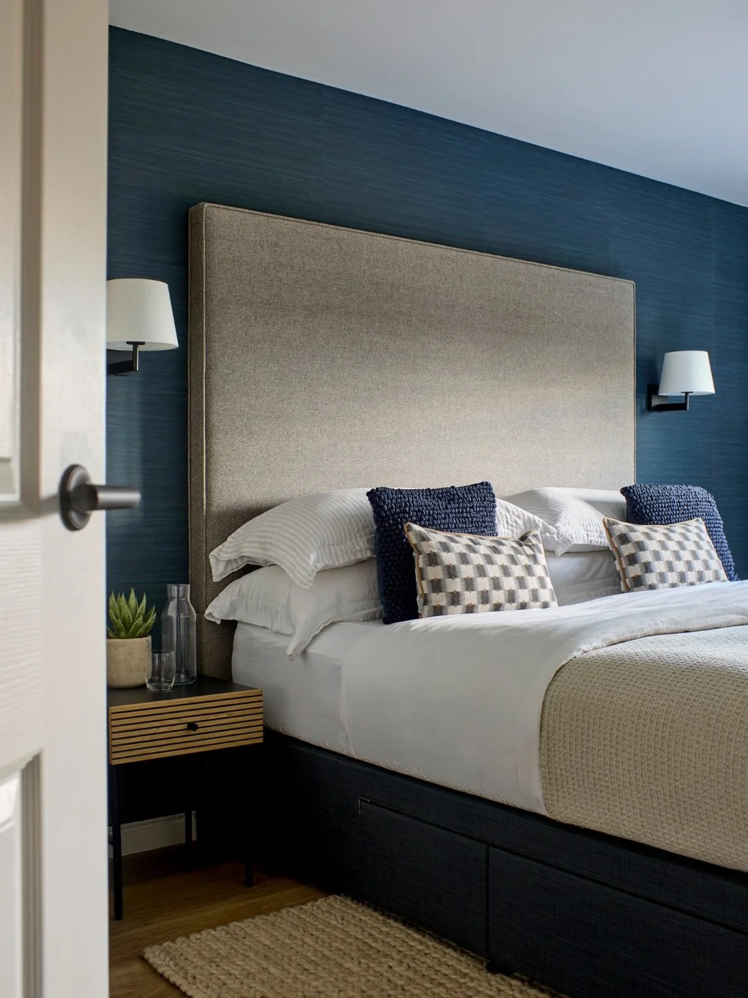 This master suite in a Woodbridge apartment was designed to feel rich, layered and completely considered - a scheme that tells a story from the moment you walk in 🐚 

THE BEDROOM ✨

We worked to build a textured look throughout, with soft wood tones