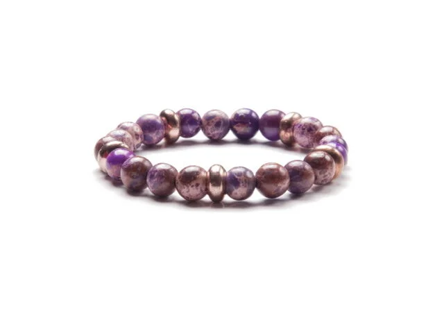 A purple and pink pearl bracelet with a stretch elastic band on a white background.