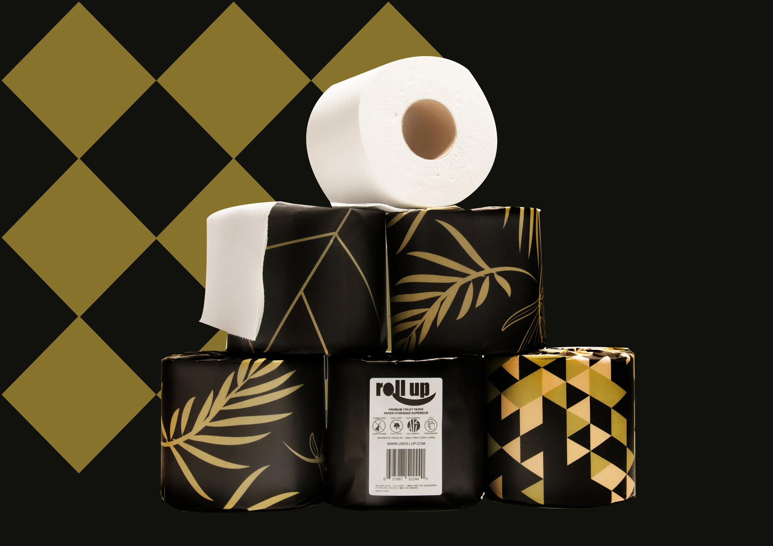 A stack of five black and gold patterned toilet paper rolls with a partially unrolled roll on top, set against a black background with gold diamond shapes.