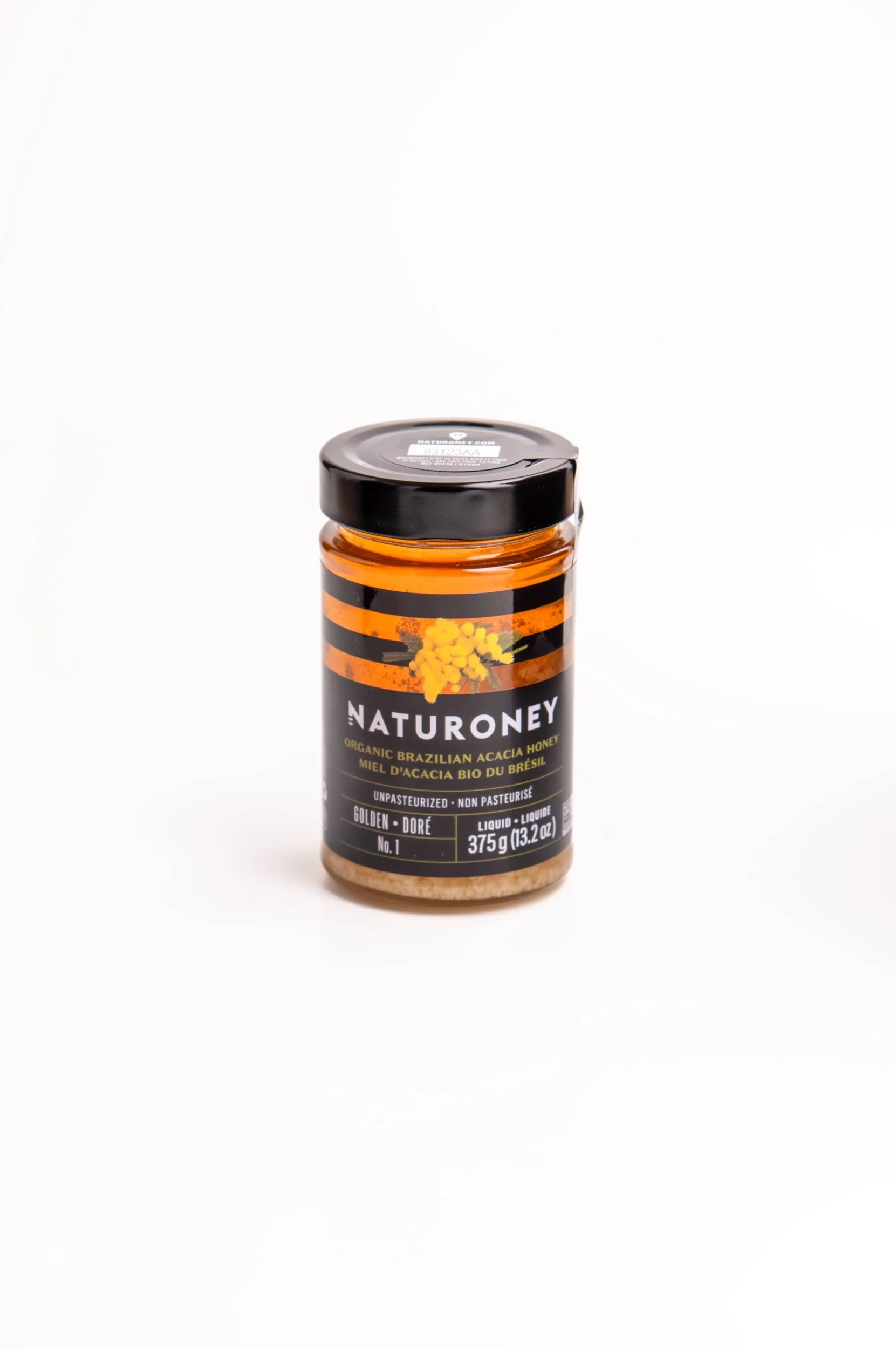 A jar of Naturoney organic Brazilian acacia honey on a white background.