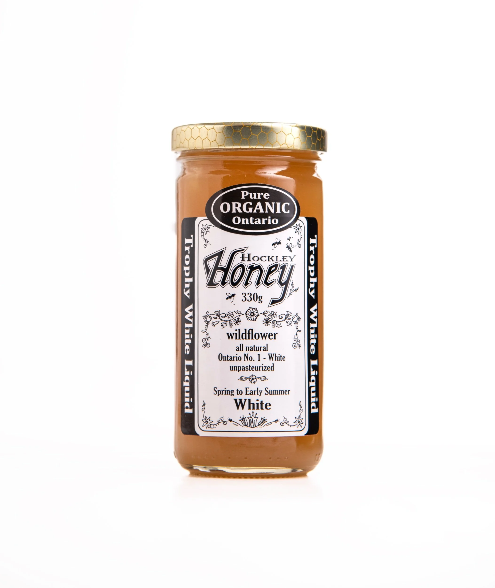 A jar of Hockley Honey, Wildflower, Ontario, 330 grams, unpasteurized, all-natural, white honey with gold lid.