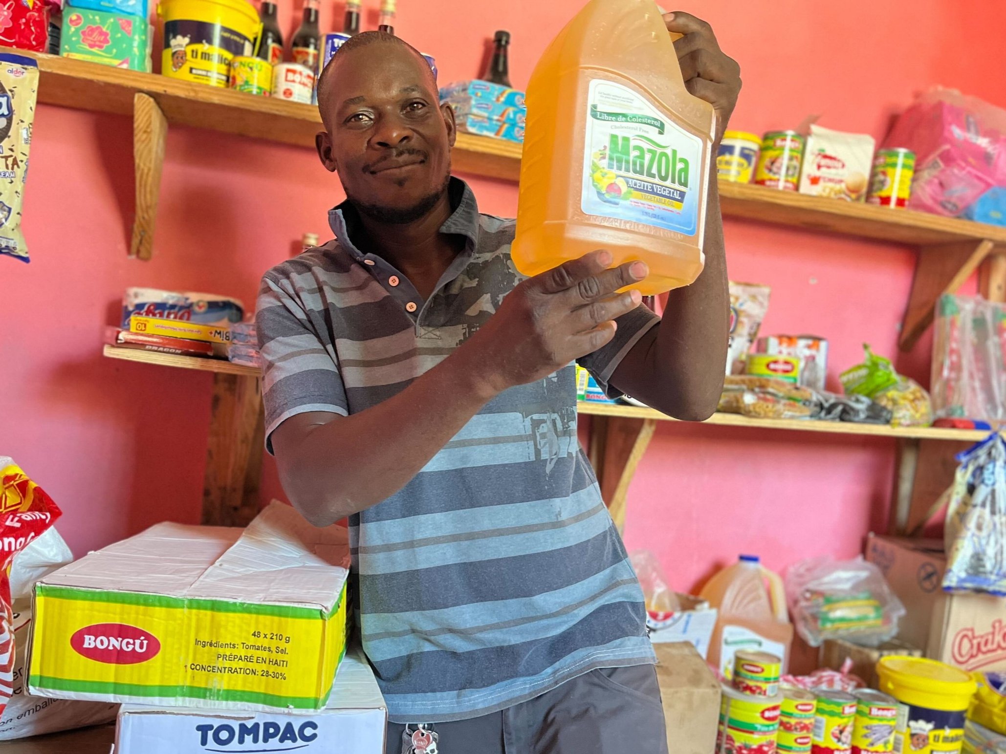  Renaud is a participant in our current cohort of our Small Business Program. As a builder, he also built his stop with his own two hands. Brick by brick, shelf by shelf, and with some of our support, filled with inventory to sell to his neighbors. 