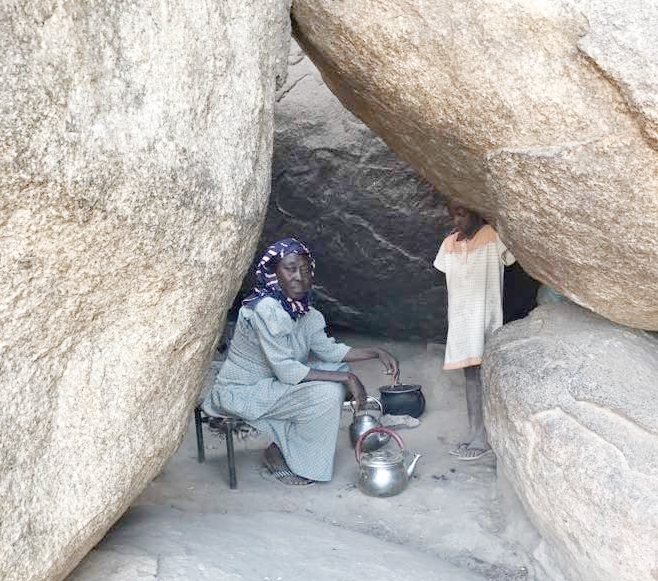 Mariam making tea in her cave home.