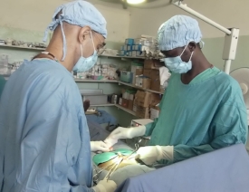 Dr. Ahmed (right) in surgery with Dr. Tom Catena.