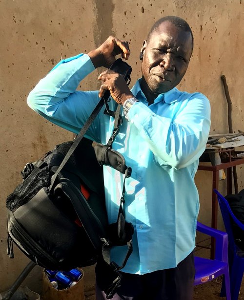 Pastor Matta with backpack projectors and audio Bibles.jpg