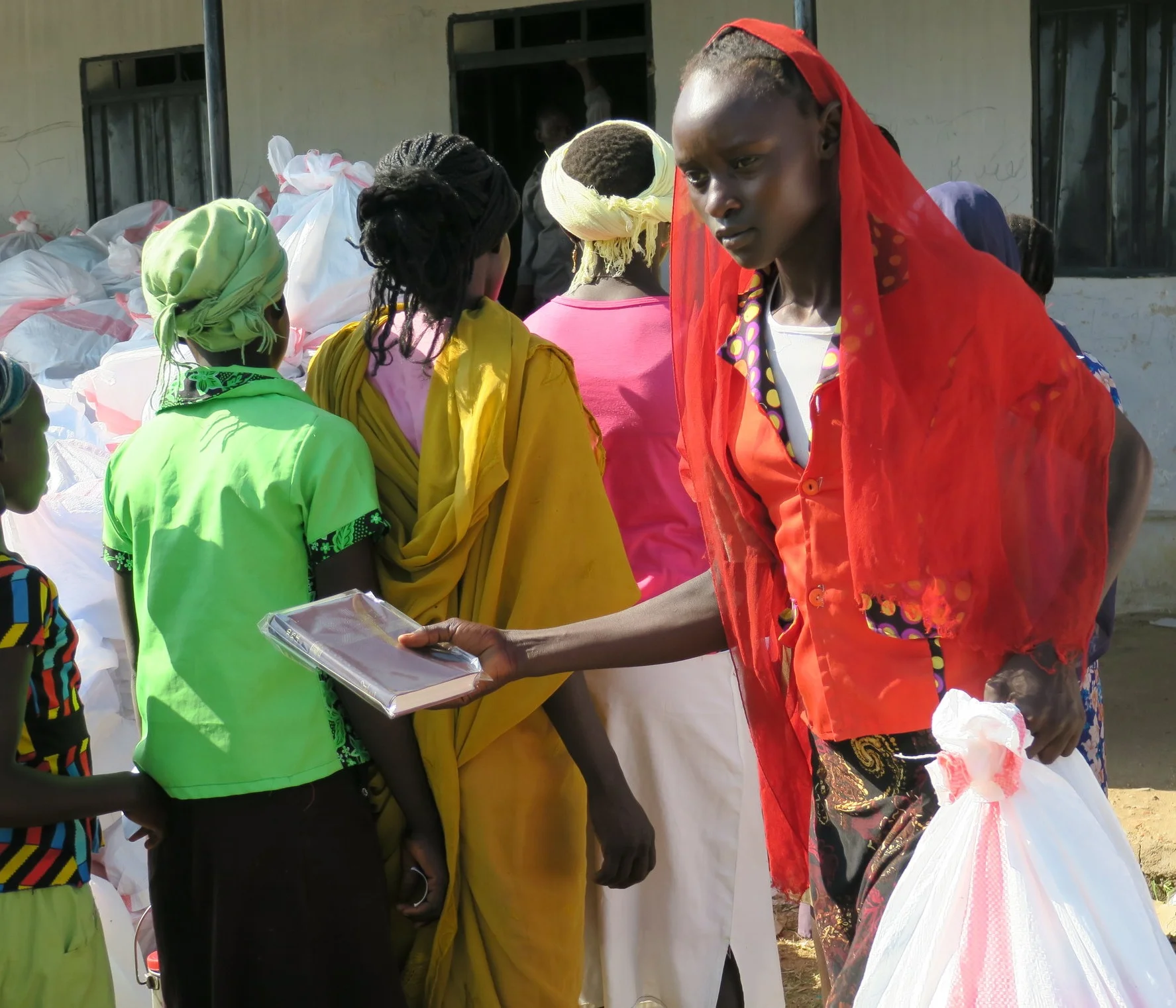 Bibles and New Testaments are handed out with our emergency relief packs.