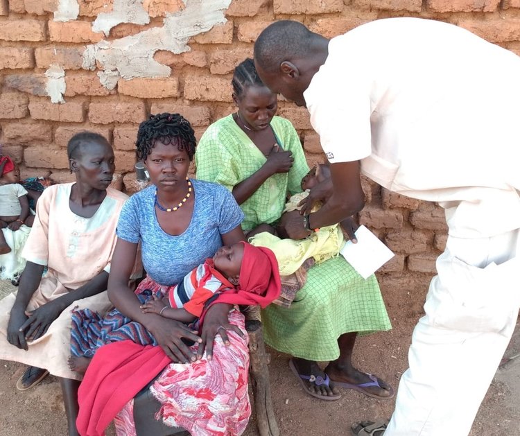 Dr. Ahmed examines infants at his hospital.