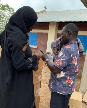 Pastor Matta shows a woman how to use an In Touch Messenger audio Bible.