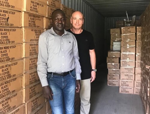 Bibles and New Testaments are distributed.