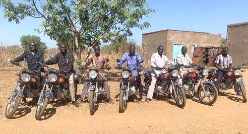 Pastors receive motorbikes.