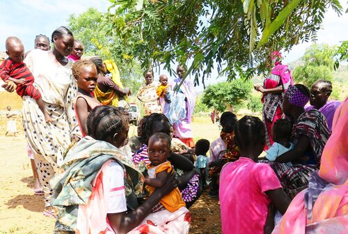 Nuba women and children waiting outside for medical treatment