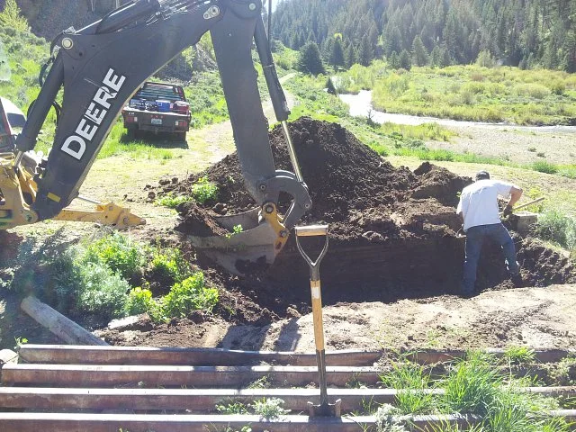 The trap under the cattle guard being cleaned out and rebuilt.