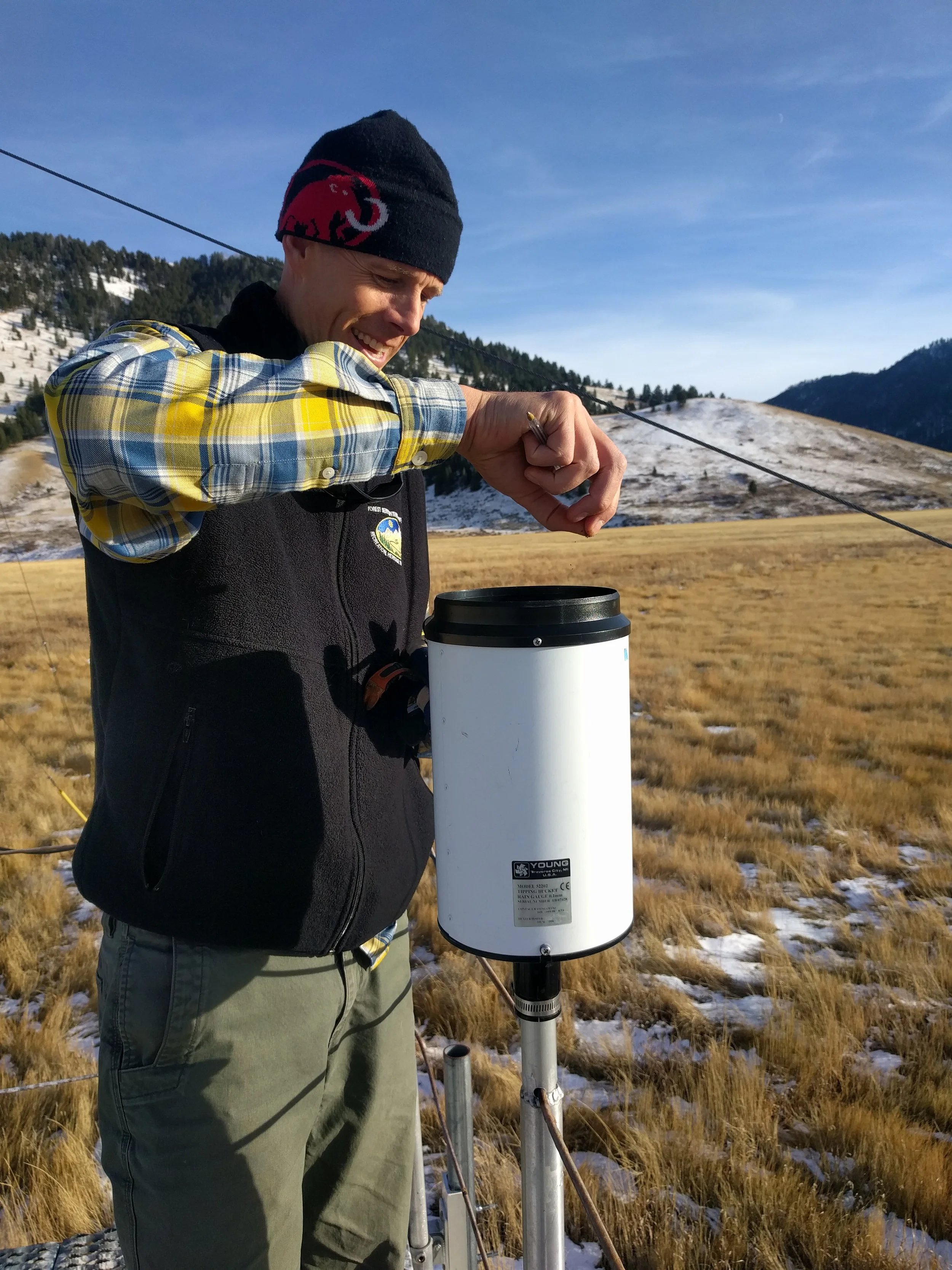 Robb removing bird droppings from the rain gauge.