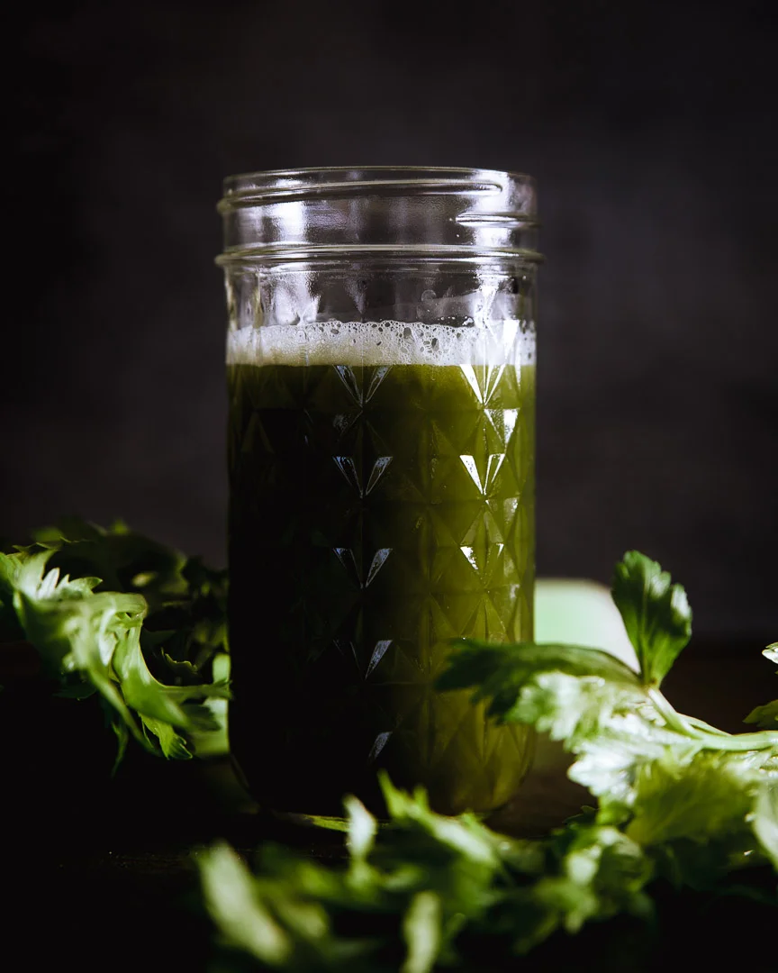 celery juice shot with moody background and light. Sarah Ehlinger / Brand Spanking You Brand Photography