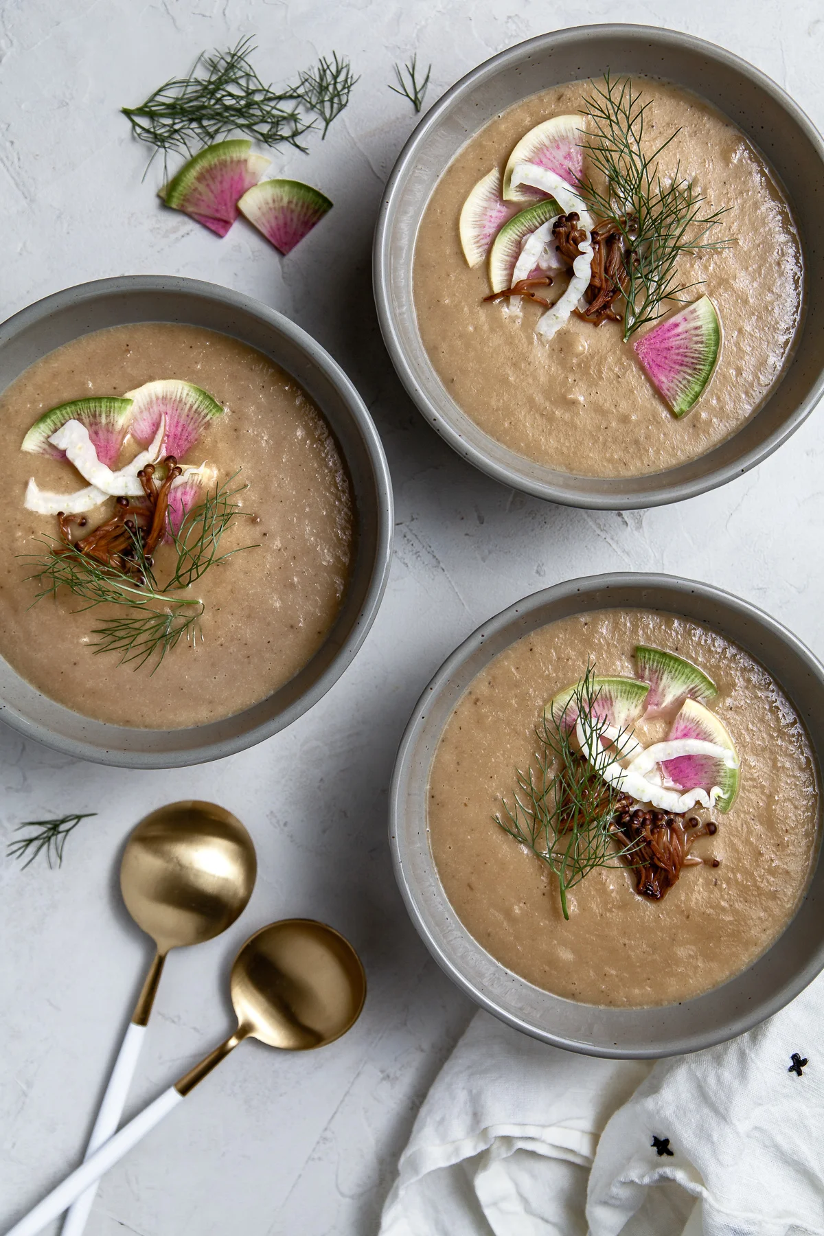 roasted fennel and celery soup. topped with radish and golden enoki.