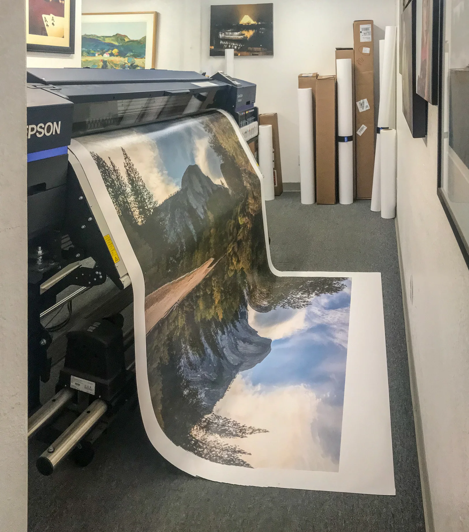 The canvas print emerges out of the printer.