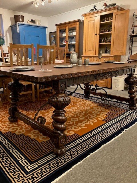  2231077 Exceptional, Walnut, Dining Table. Circa 1900. No veneer. Top is 1  5/8” thick. Skirts at both ends pull out with fold down support legs for large length extensions. Large legs are carved and splayed out. Iron decoration under top. Main top 