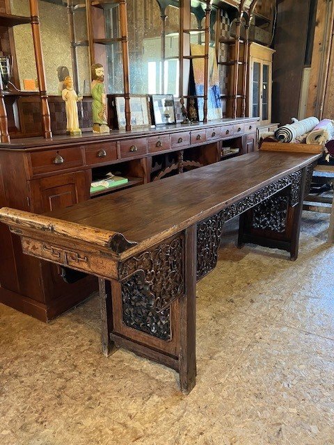  2231079 Asian, Teak, Serving Table. Mid-1800’s. Hand-carved floral skirt and thru-carved panels between the legs. 9’3” L x 22.25” W x 37” H (34.5” H at flat surface). $2250 