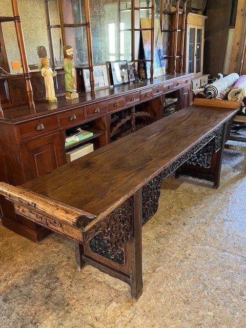  2231079 Asian, Teak, Serving Table. Mid-1800’s. Hand-carved floral skirt and thru-carved panels between the legs. 9’3” L x 22.25” W x 37” H (34.5” H at flat surface). $2250 