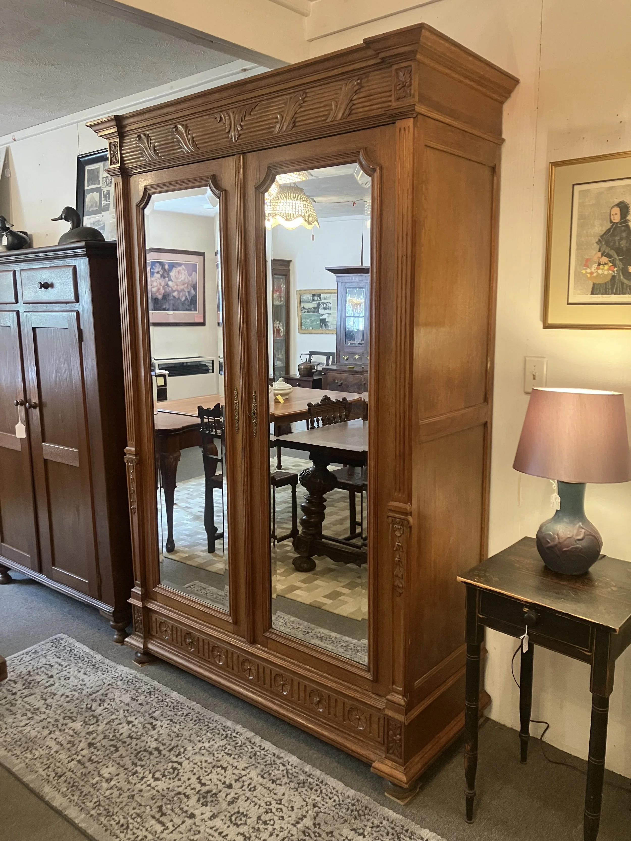  2261036 French Armoire. Two doors with beveled mirrors above one drawer. Circa 1880. 55.75” W (at top) x 22.5” D (at top) x 84”H. Comes apart for moving. $2300. 