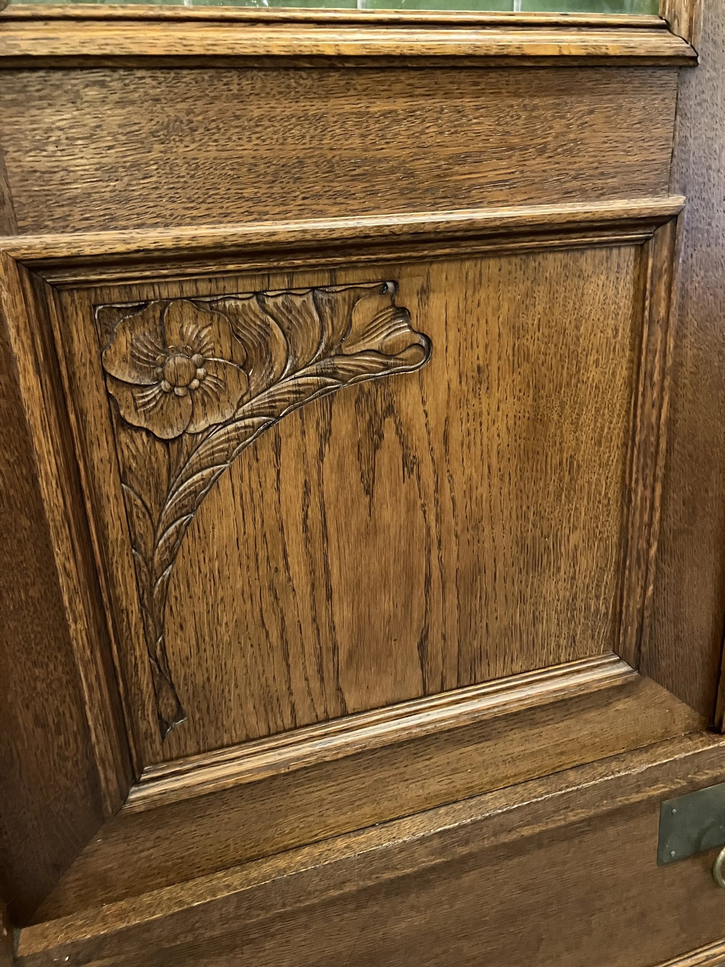  2261037 Door Panels on Belgian, Oak, Bookcase. Two doors with leaded glass and Art Nouveau carved panels. One drawer. Circa 1900. 42” W x 16”D x 87” H.  
