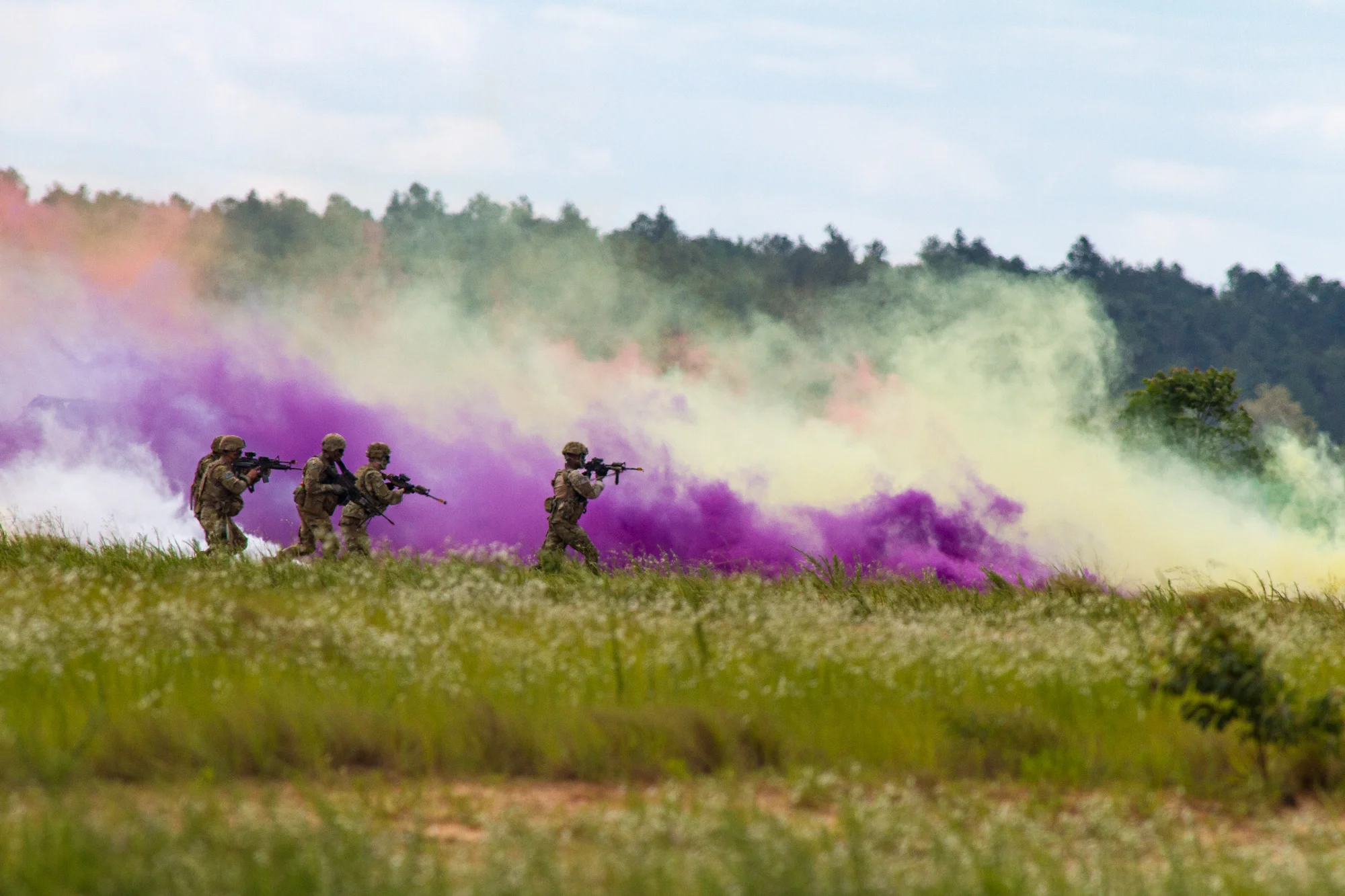 Paratroopers from the 82nd Airborne Division simulate an assault of a compound under cover of smoke as part of the Airborne Review at Sicily Drop Zone at Fort Bragg, N.C., on Thursday, May 25, 2017.