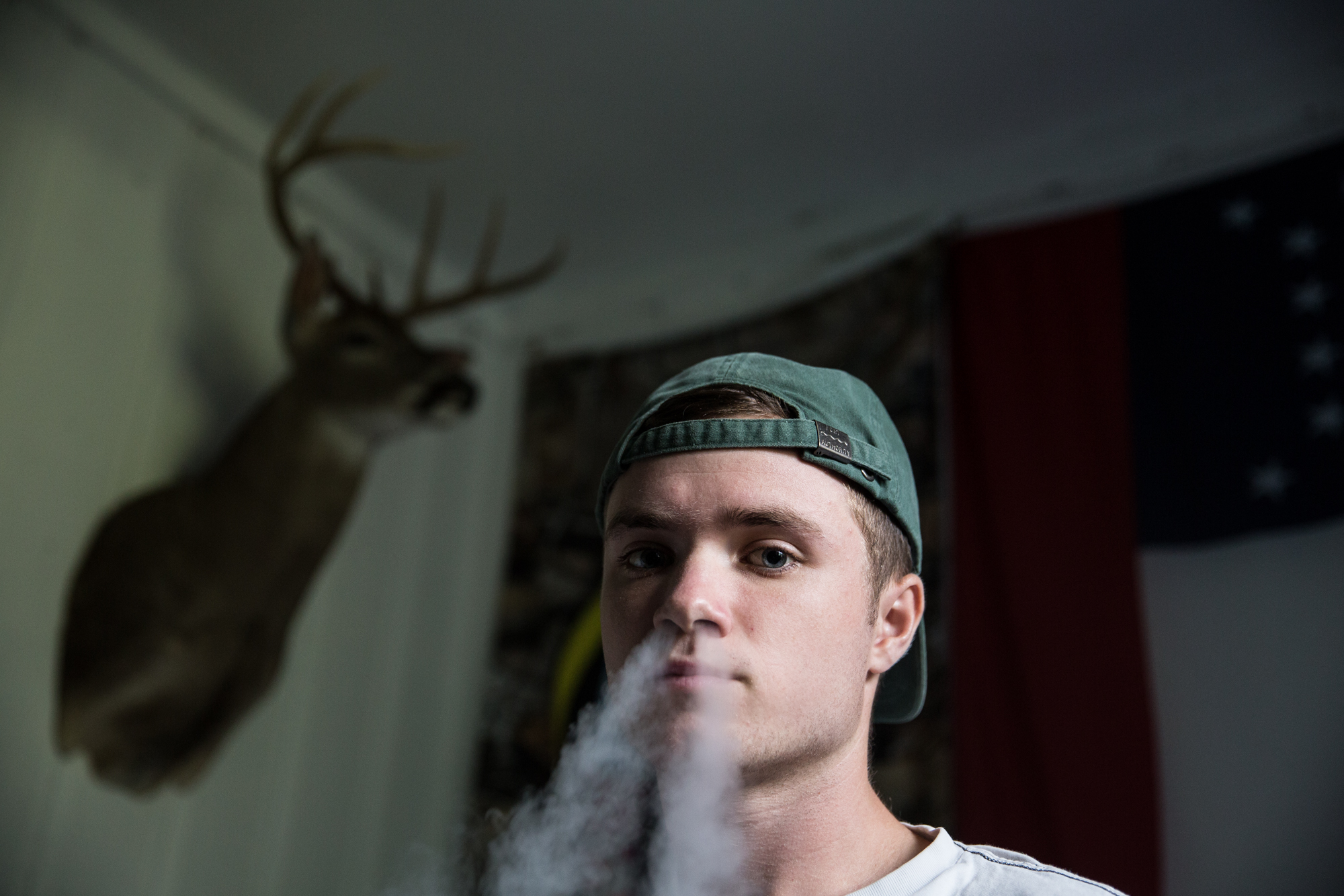  Cole Fanning-Haas, from Los Angeles, California, sits in his fraternity house at the University of North Carolina at Chapel Hill while smoking an electronic cigarette. “It’s not the obvious things that make it hard to adjust to living in the South,”