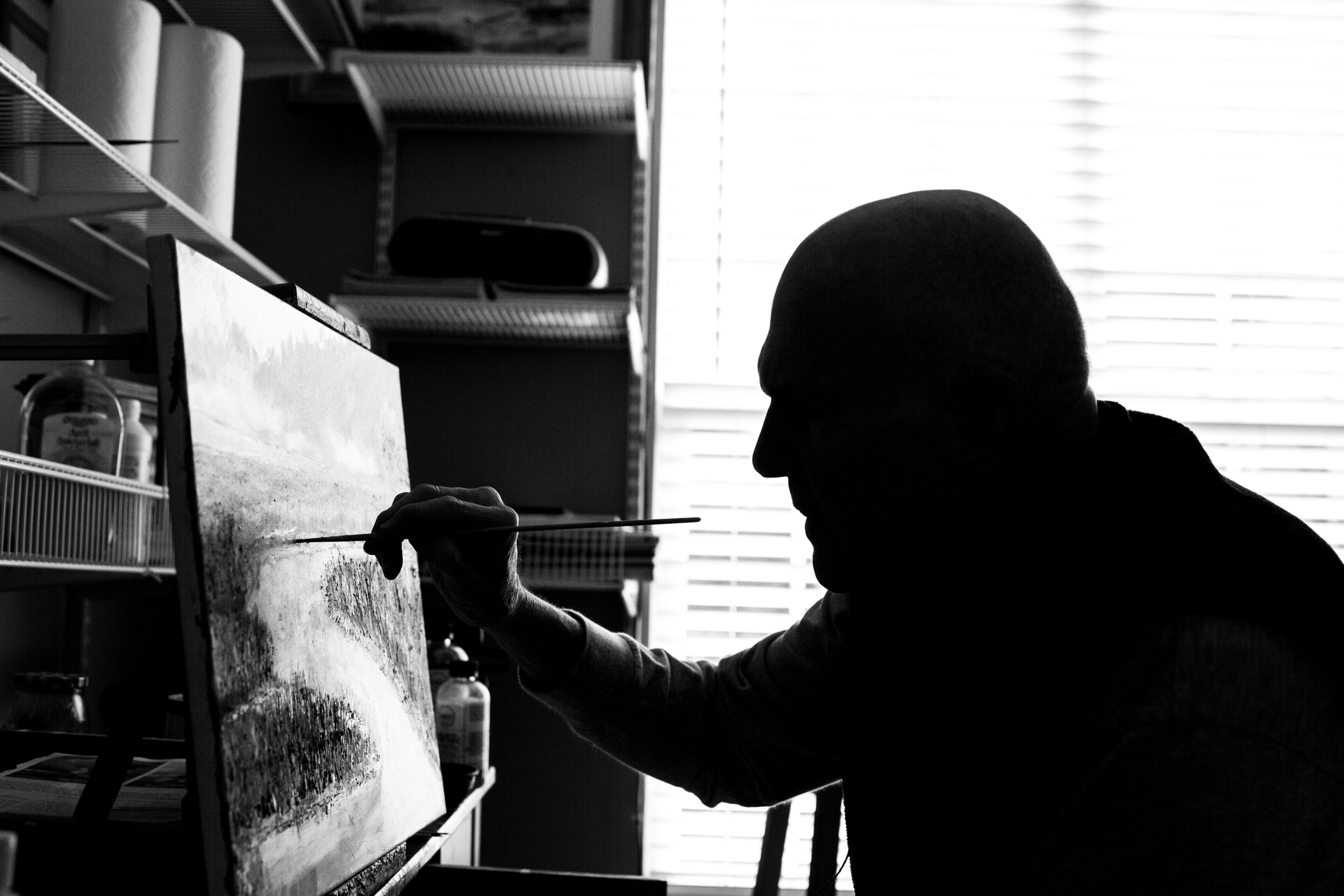Bill Wilder meticulously focuses on his painting. Bill, 76, picked up painting as a hobby after retiring. "The smart thing to do would have been to pick a smaller canvas for this painting. I feel like my arms are about to fall off after painti