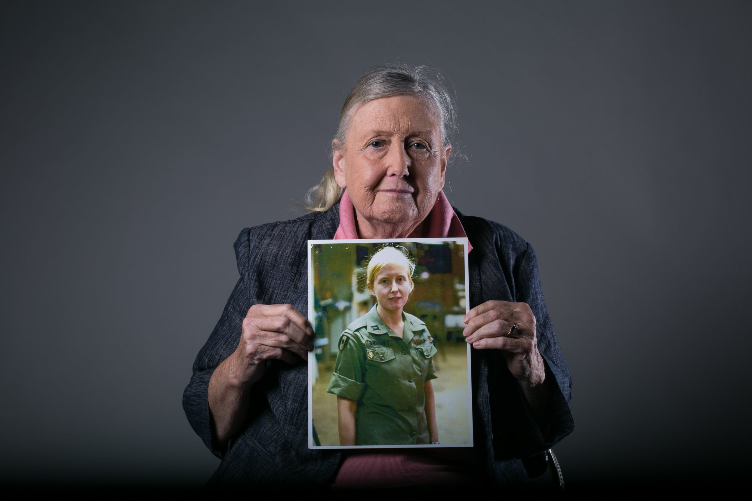 Mary Ellen Shugart of the Army Nurse Corps, holds a picture of herself from her time as a nurse in Vietnam.