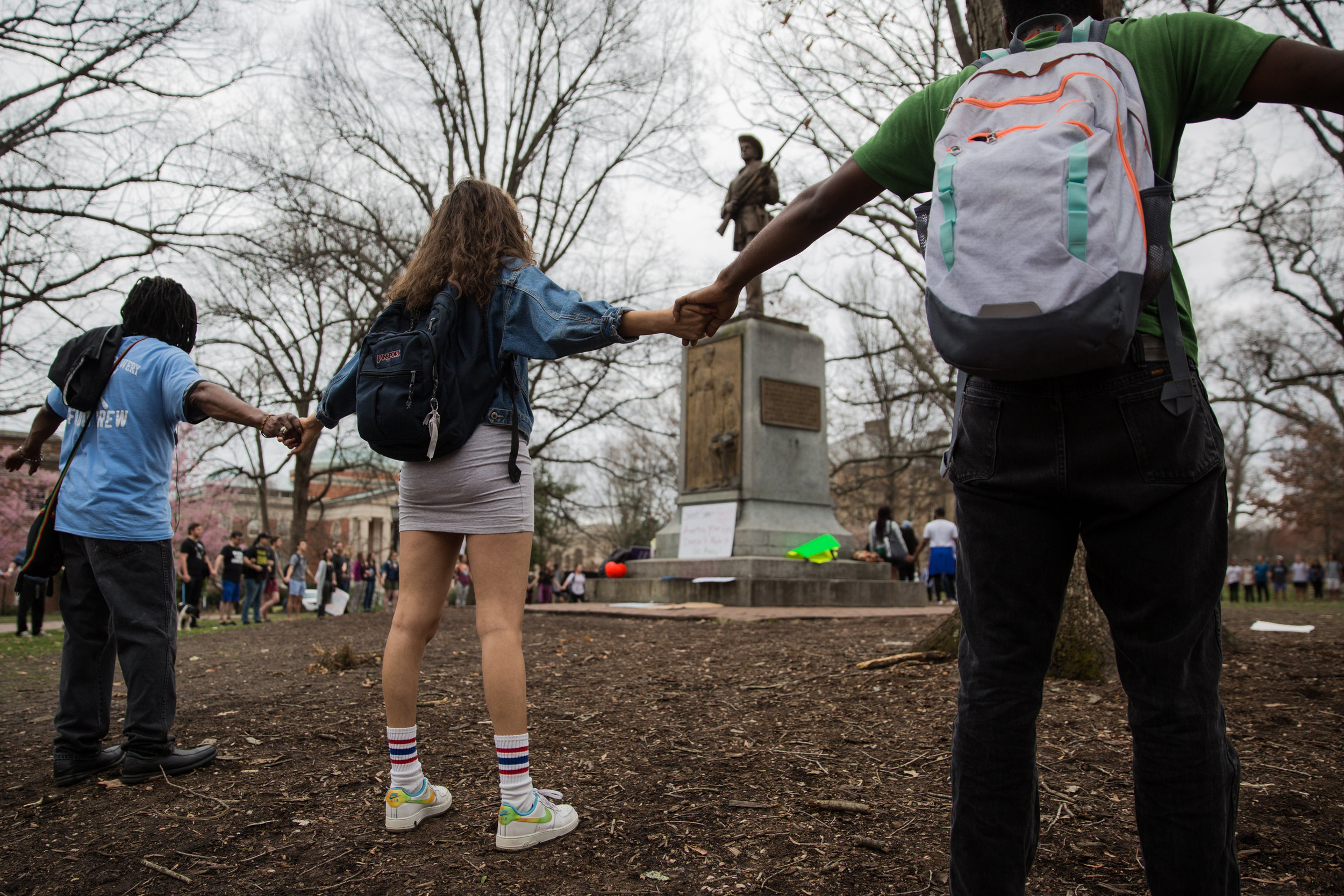  Students gather and hold hands in a circle around the Silent Sam monument at the University of North Carolina at Chapel Hill. A large demonstration formed around the statue to protest the statue’s position on the university’s campus on February 21, 