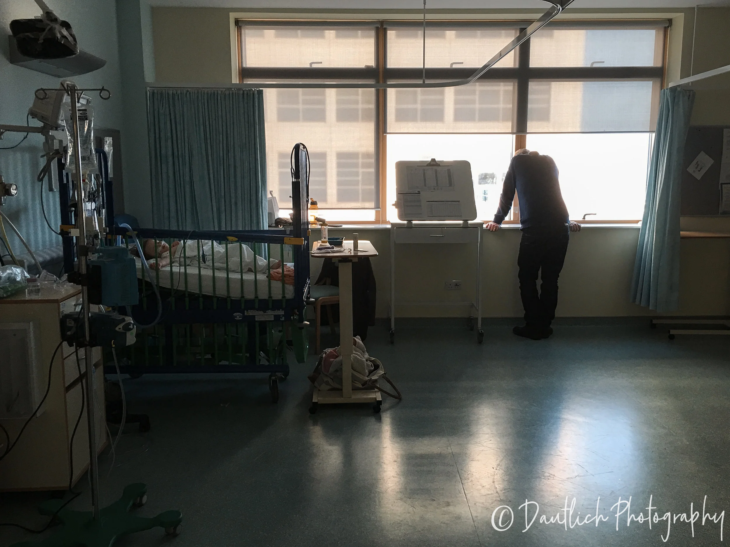 Nick looking out the window after Hazel was sedated and resting on the breathing machine.