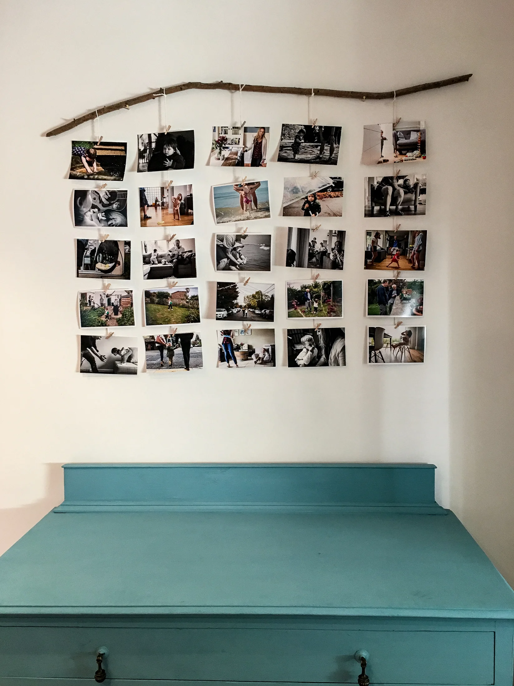 Found stick used to hang several 6x4 photographs in a natural and interesting display.