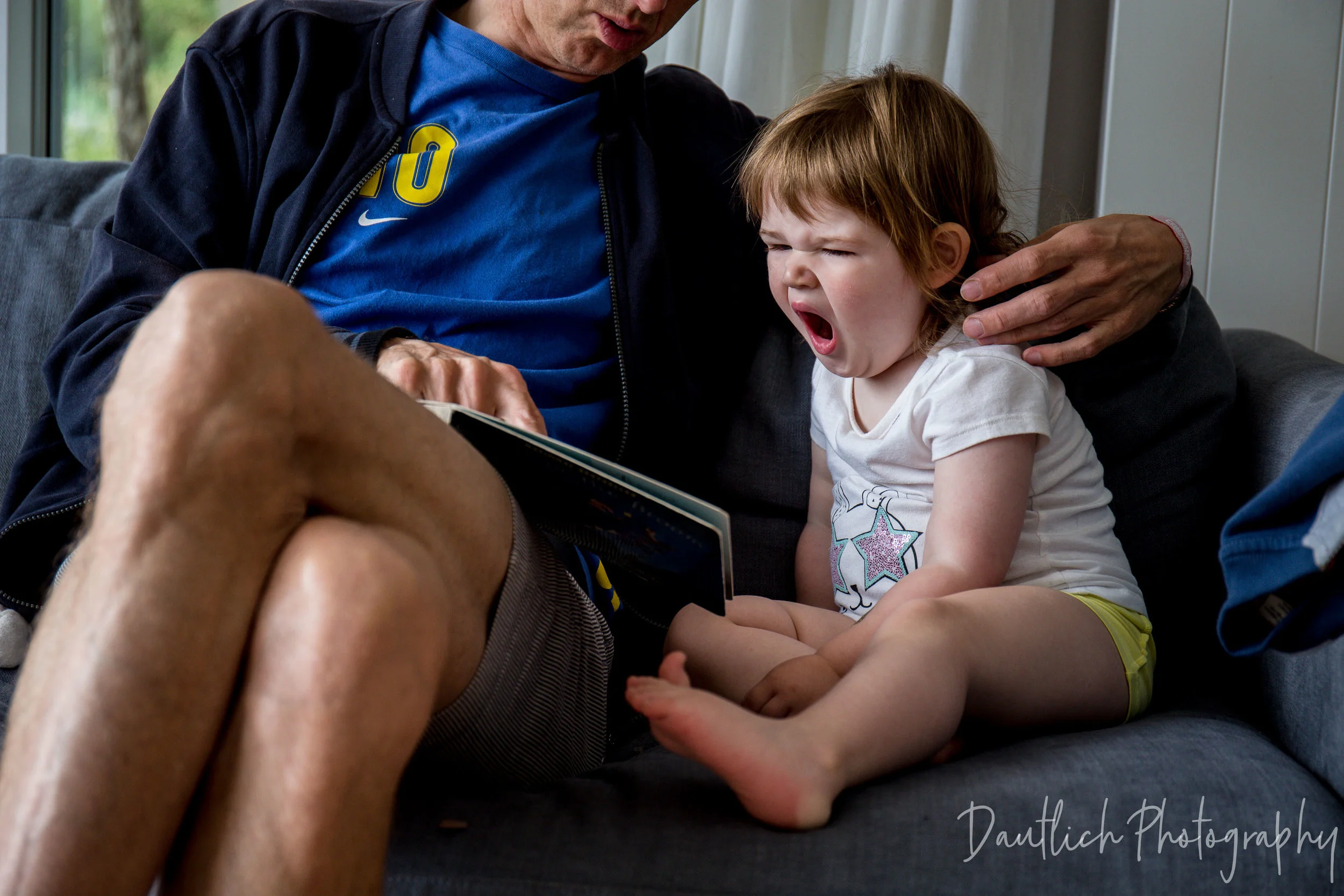 Uncle Marc reading stories and books to toddler Hazel during our family holiday at Cotwolds Waterpark in Summer of 2018.